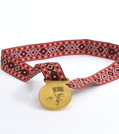 Medal awarded to all participants in the games. Photo courtesy of 3-2-1 Qatar Olympic and Sports Museum © 2026.