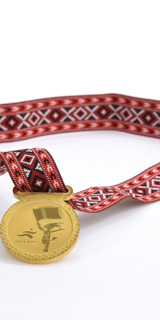 Medal awarded to all participants in the games. Photo courtesy of 3-2-1 Qatar Olympic and Sports Museum © 2026.