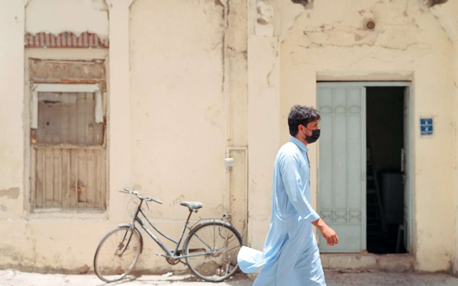 worker in covid crossing a road