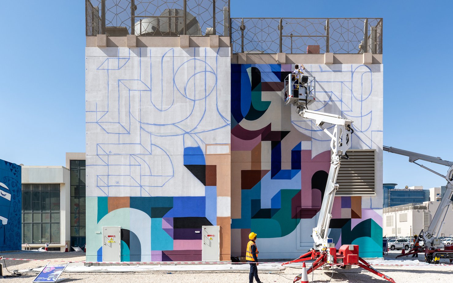 Colourful wall mural being created