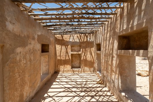 Inside an old house in Ain Mohammed village, the house has straight beams with openings as a roof.