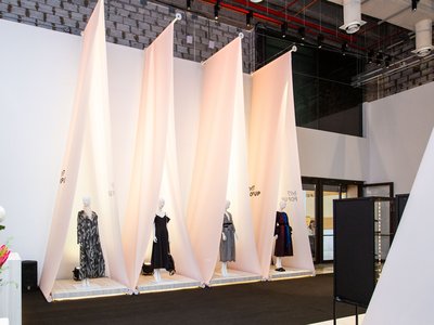 Clothes on mannequin display under a tent