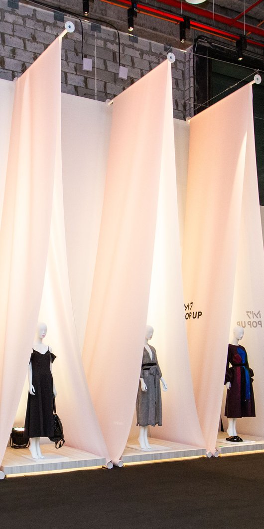 Clothes on mannequin display under a tent