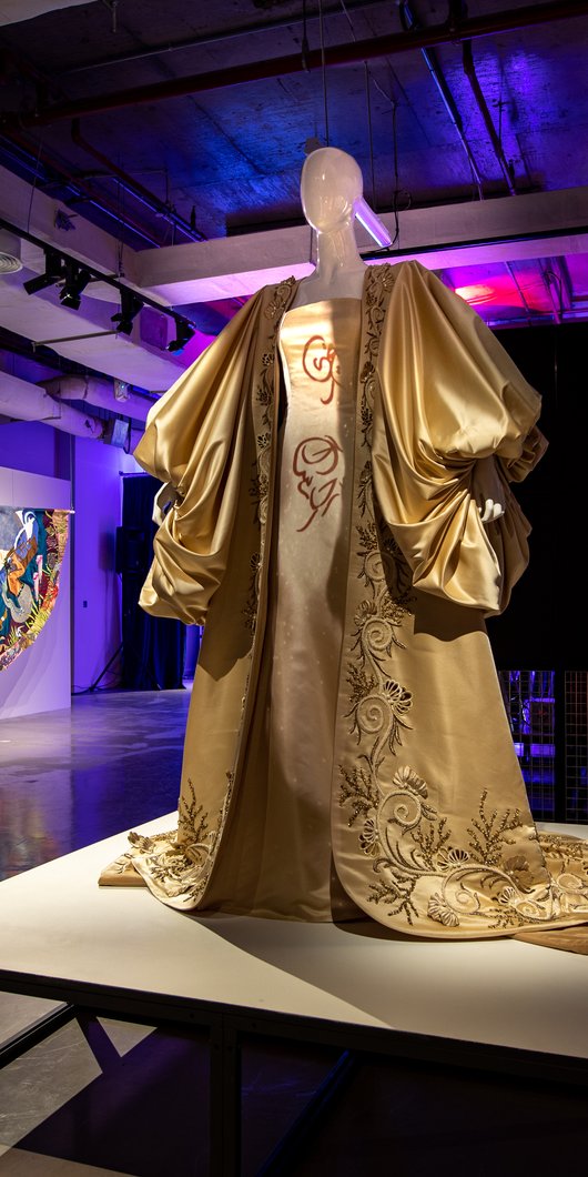 Gold dress with a cape in an exhibition display