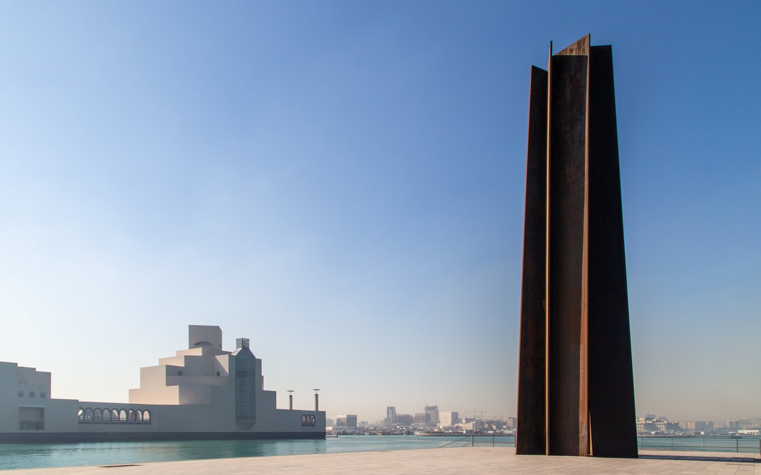 A wide-angle view of Richard Serra's sculpture '7' located right outside the Museum of Islamic Art, Doha