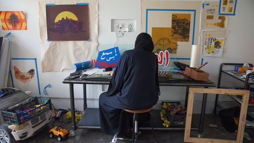 Artist Sara Al-Fadaaq working in her studio at the Fire Station.
