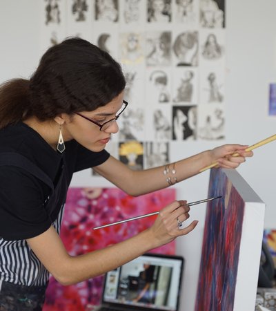 Artist Sarah Al-Ansari working in her studio at the Fire Station.