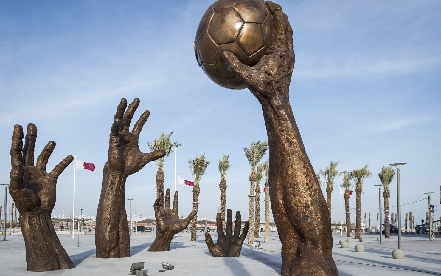 image of sculpture of hands lifting from the ground