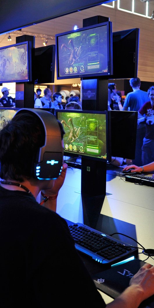Teenagers play the latest version of Starcraft at the Gamescom convention in Cologne, Germany.