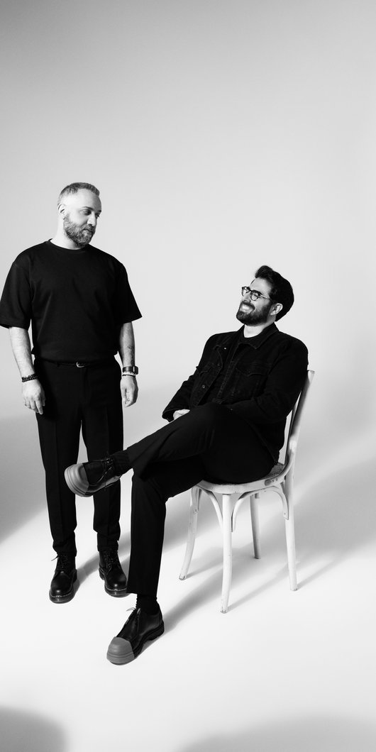Black and white photo of designer duo