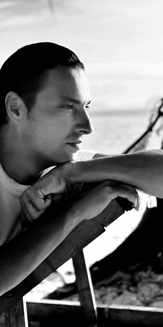 Black and white foto of designer staring away