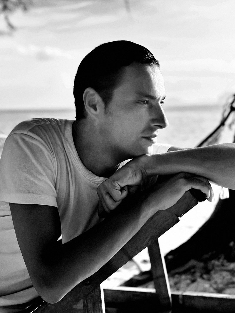 Black and white foto of designer staring away