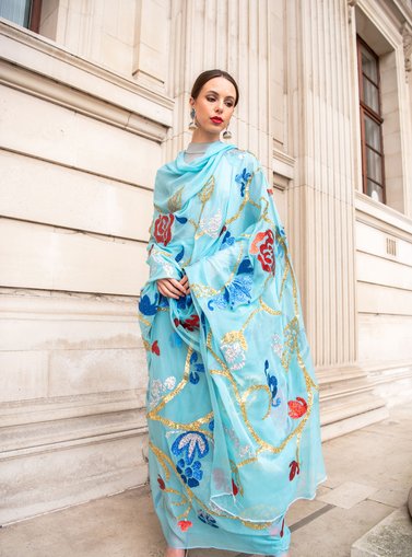 Model posing in a light blue long dress