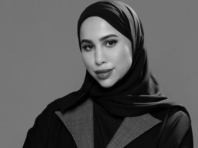 Black and white photo of woman in abaya posing