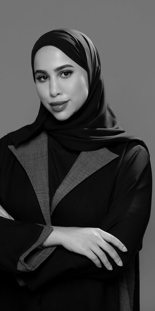 Black and white photo of woman in abaya posing