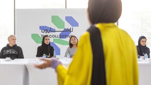 Woman showing pieces of clothing on a rack