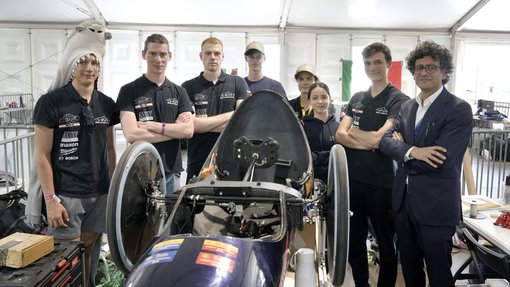 Team BME SharkTeam gathers around their prototype vehicle at Shell Eco-marathon Europe and Africa 2025, celebrating teamwork