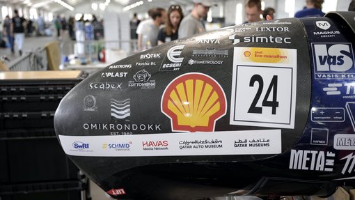 Close-up of Team BME SharkTeam’s prototype vehicle, proudly displaying sponsor logos including Qatar Museums and Qatar Auto Museum