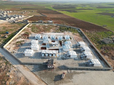 white building in a green area