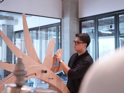 Man working on a wooden prototype