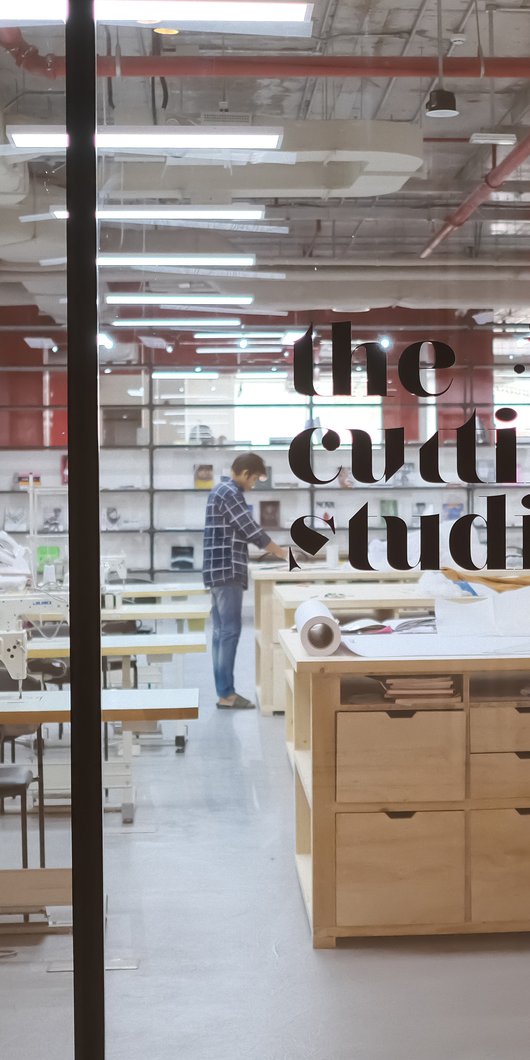 Sewing table and fashion production company space through the window