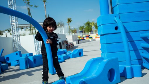 Child playing with building blocks at the Dadu Gardens.