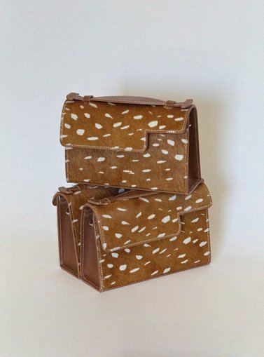 beige bags stacked on top of eachother