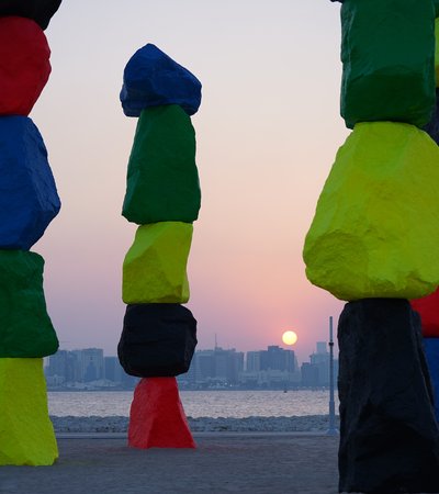 Vertically stacked rocks in bright red, blue, green, yellow and black.