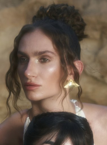 Model posing with big earrings