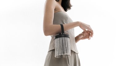 woman holding an encrusted bag