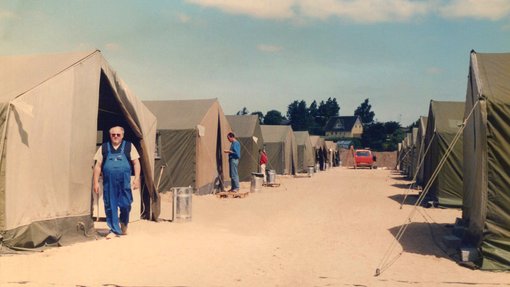 a man standing in front of a tent
