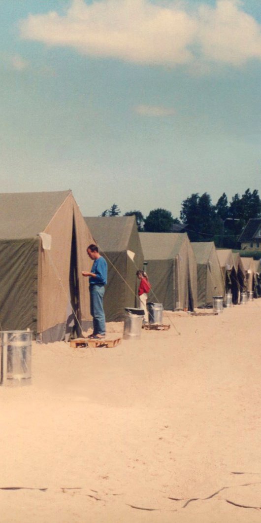 a man standing in front of a tent