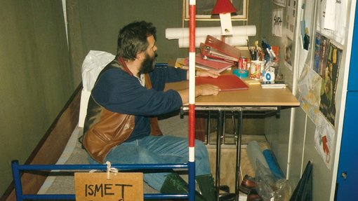 a man sitting on a bed