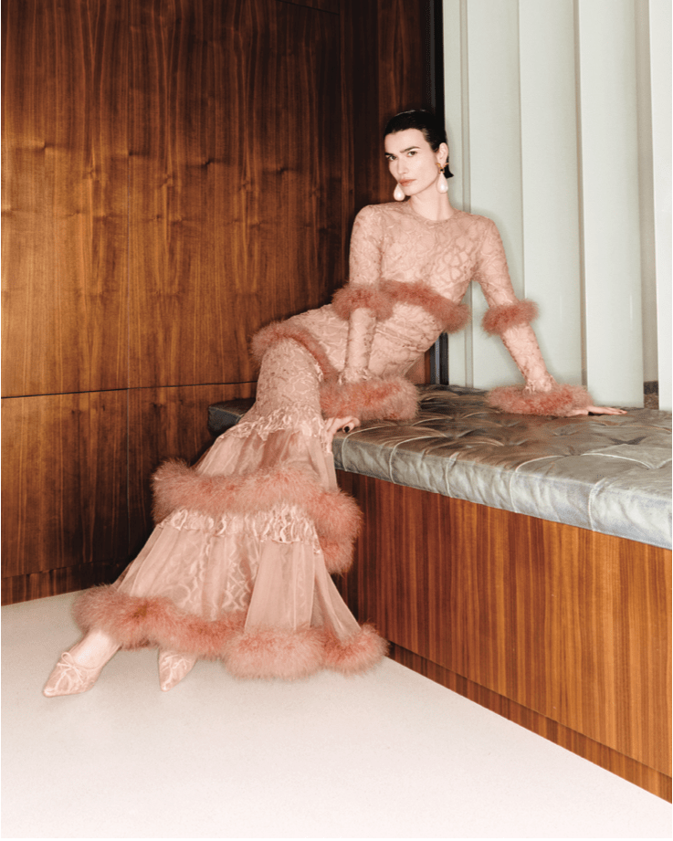 Model sitting in a long evening gown light pink