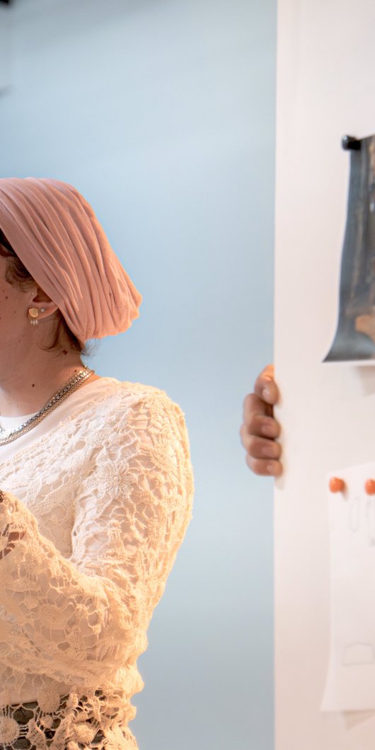 woman holding a piece of paper explaining something