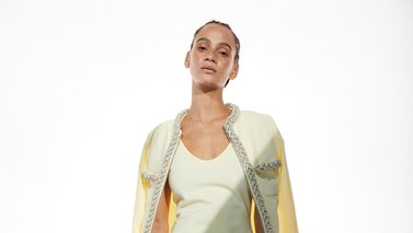 Model in a short beige dress