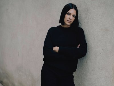 Woman leaning on a wall