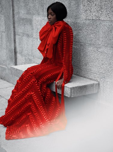 Model in bright long red dress