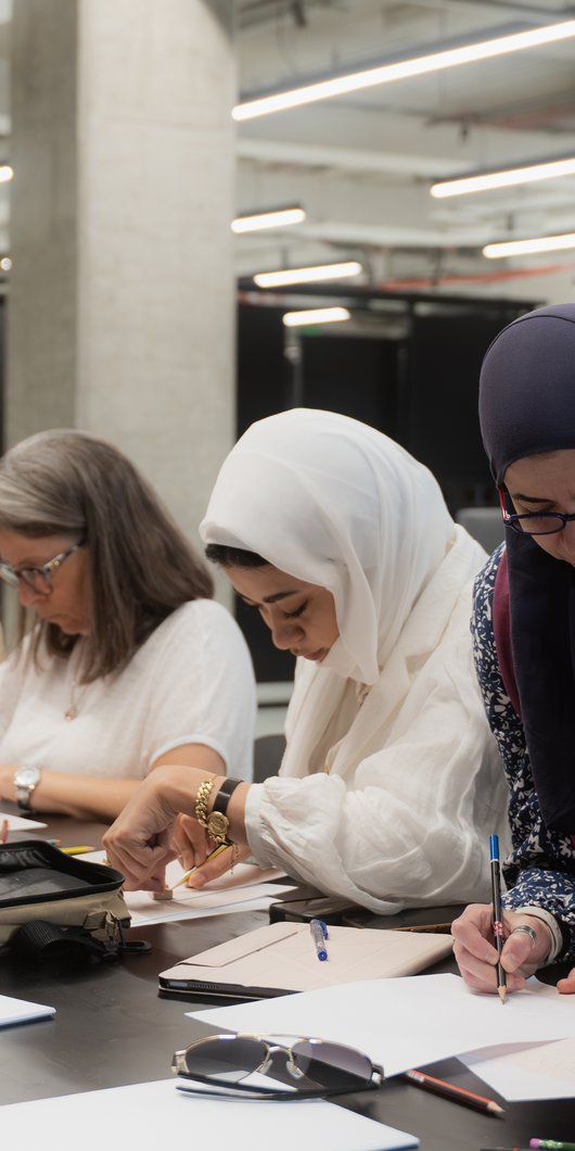 group of women workin and sketching at a table