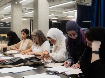 group of women workin and sketching at a table