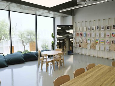 Vibrant room for kids with giant beanbags and artwork wall