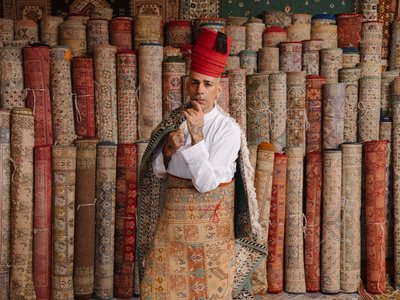 Designer posing in front of fabrics