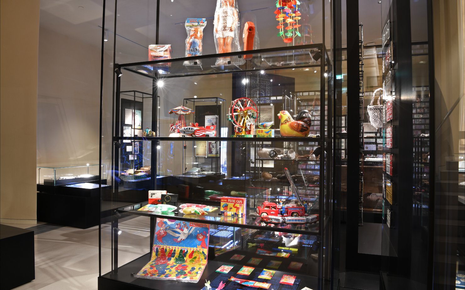 A glass cabinet full of children's toys