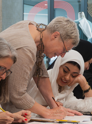 Group of women writing something on the table
