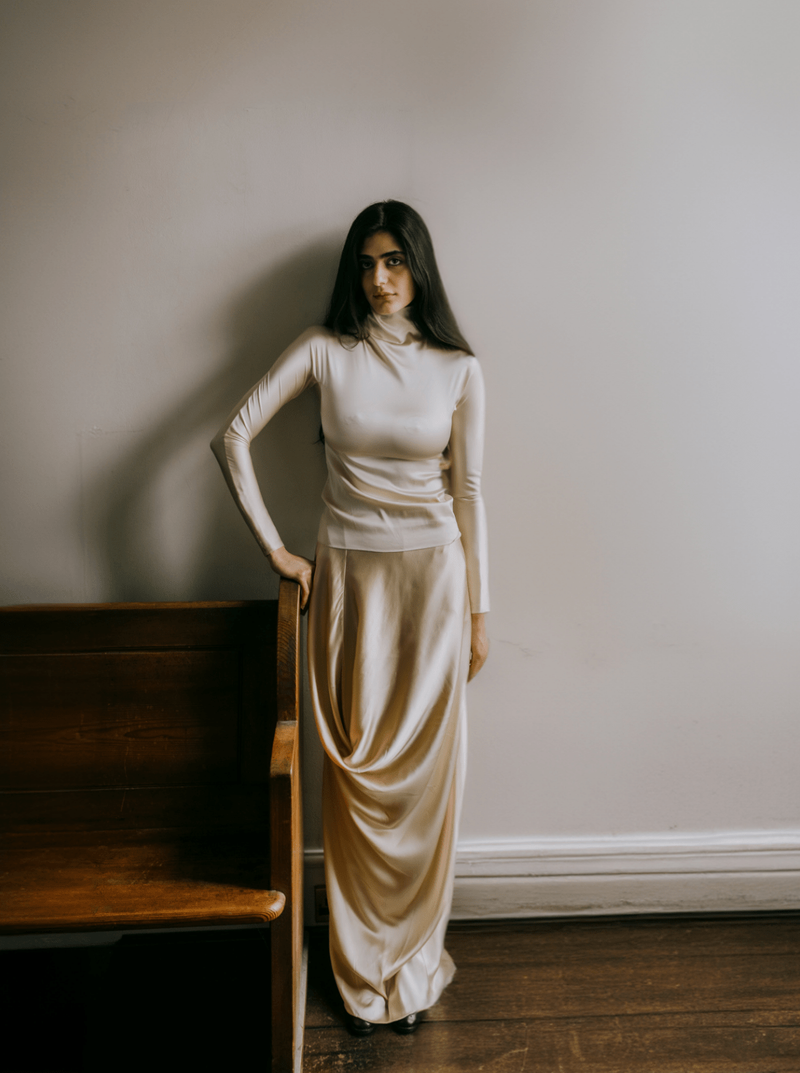 Model posing in beige tones