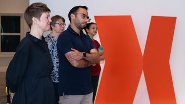 group of adults observing an art piece