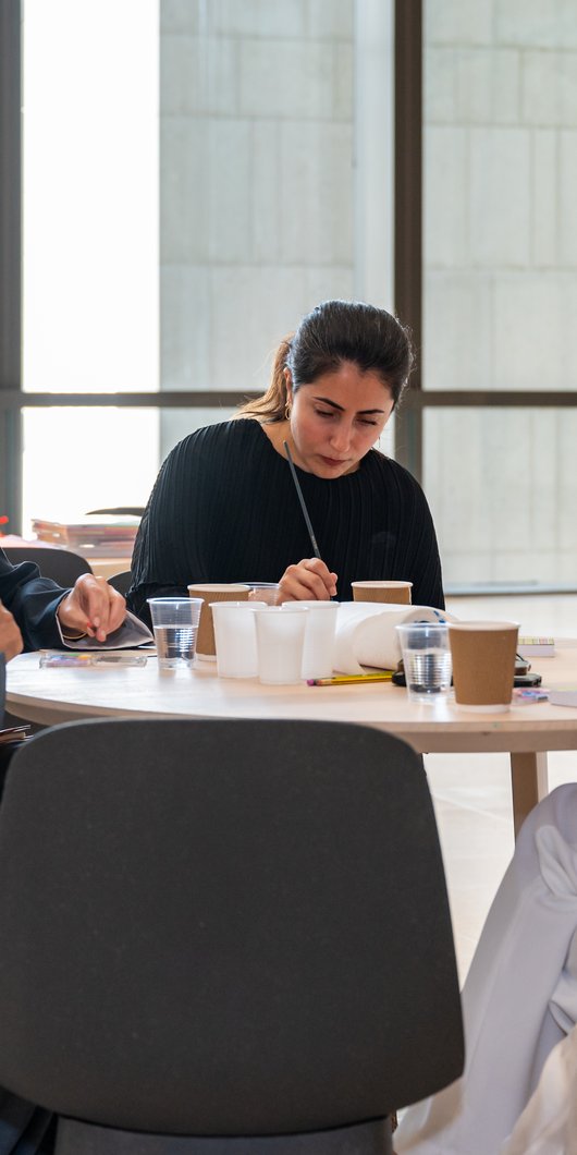 Group of adults sitting in one table doing crafts