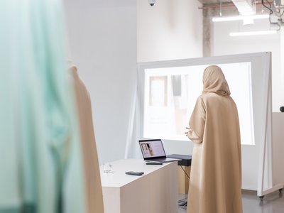 Women standing with a laptop presenting