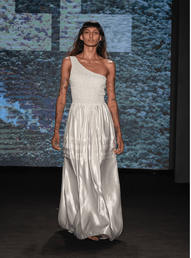 Woman in a long white dress on the catwalk