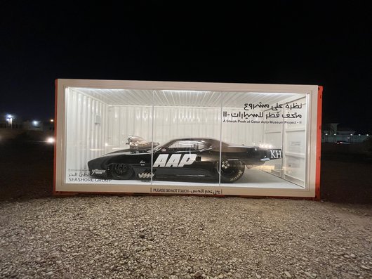 A black 1969 Chevrolet Camaro, Pro-Modified in a display case.